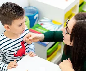 Speech therapist guiding child